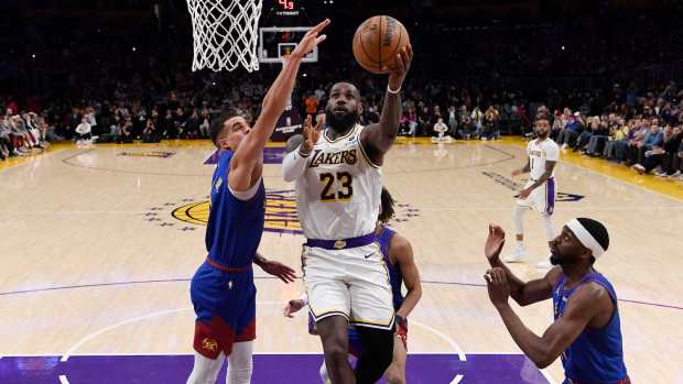 LeBron James #23 of the Los Angeles Lakers scores his 40,000th career point during the first half against Michael Porter Jr. #1 of the Denver Nuggets at Crypto.com Arena on March 2, 2024 in Los Angeles, California.