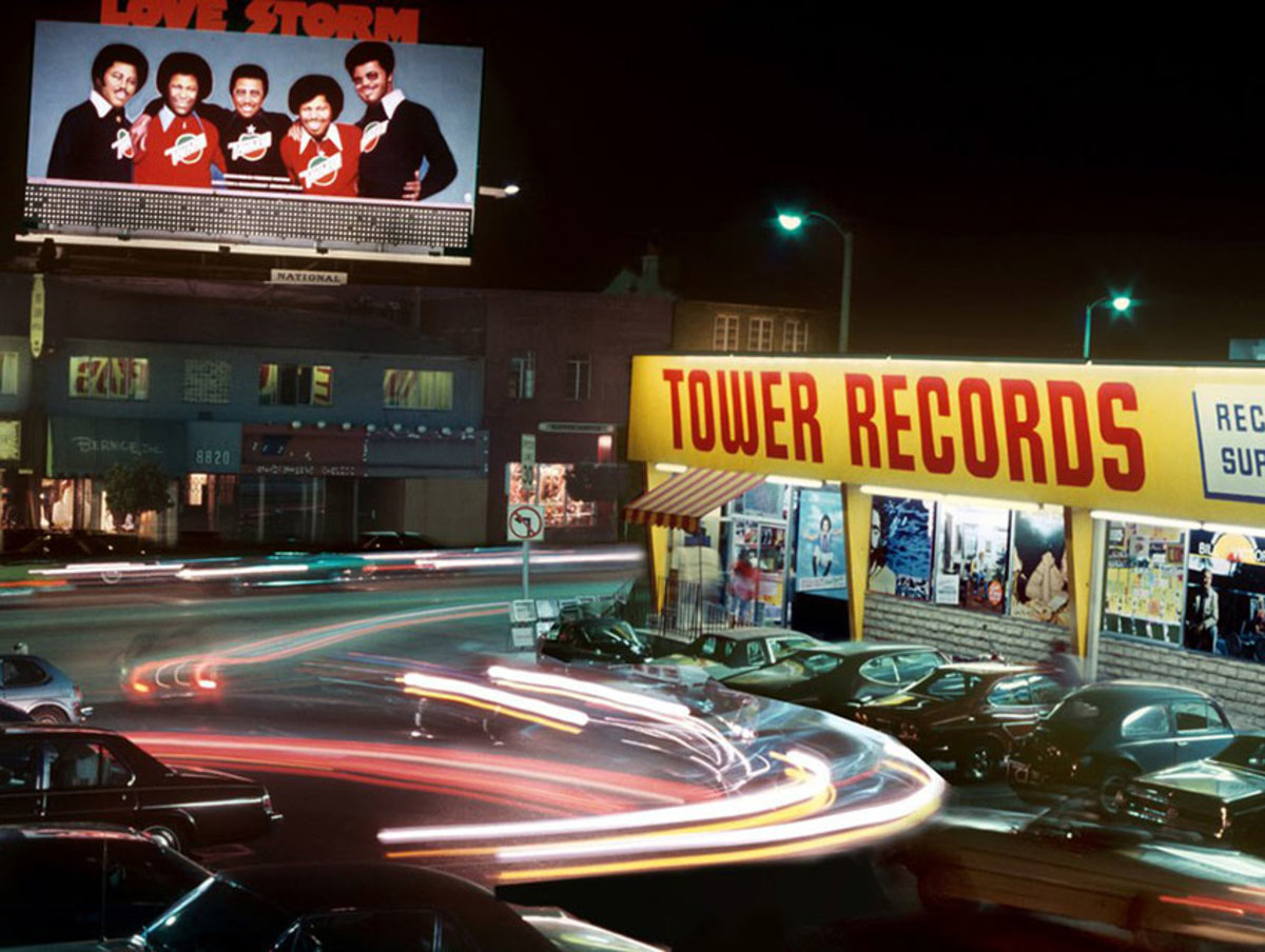 A man walks past a billboard advertisement of Keith Richards