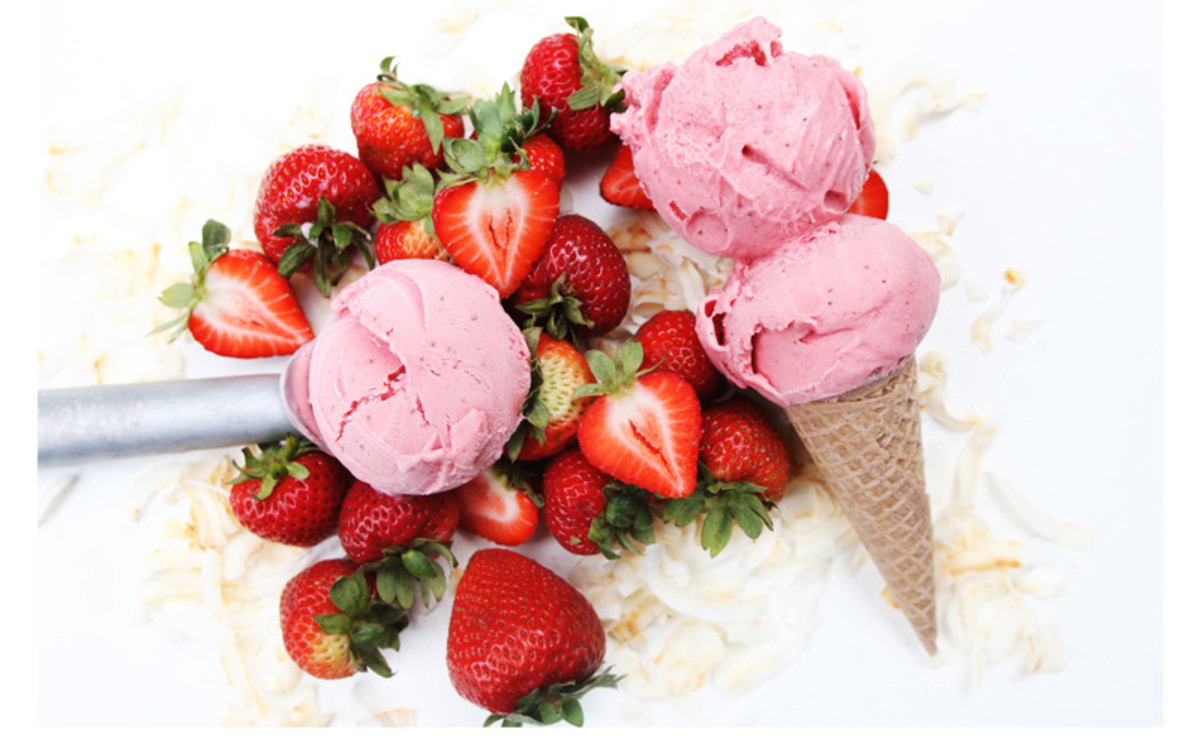 Pink strawberry and coconut ice cream scoops on plate stock photo